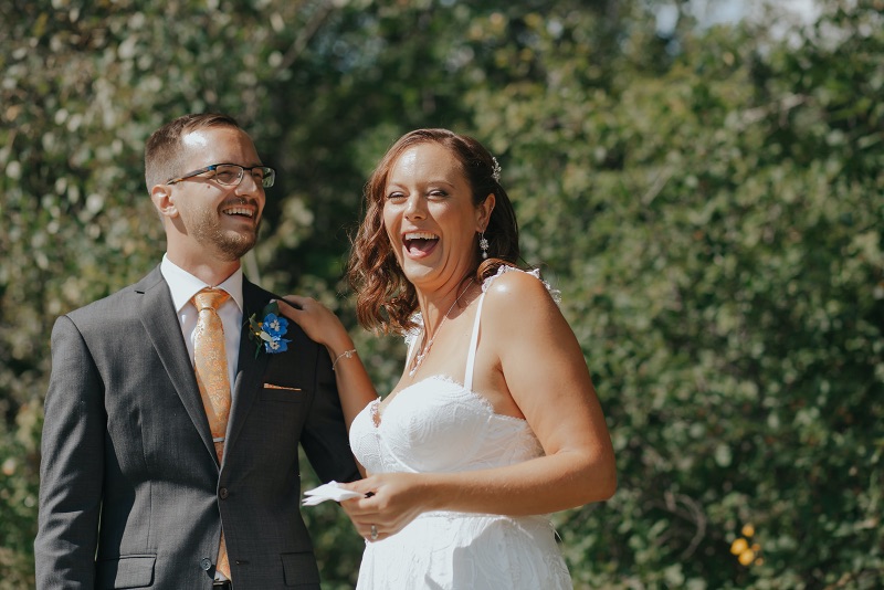 Couple laughing together before their backyard wedding