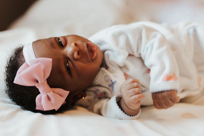 cute newborn baby girl with bow