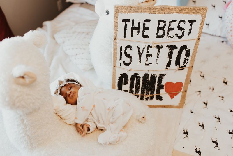 posed newborn with signs